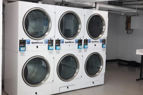 a utility room with dryer washer and a washing machine