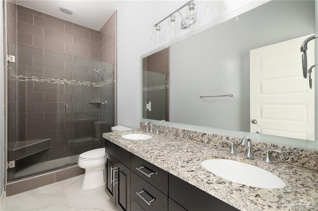5307 North Crown Point Pharr, TX 78577 - Photo 8 of 11 Bathroom featuring double vanity and a stall shower