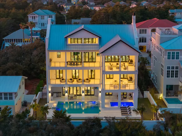 an aerial view of multiple houses with a yard