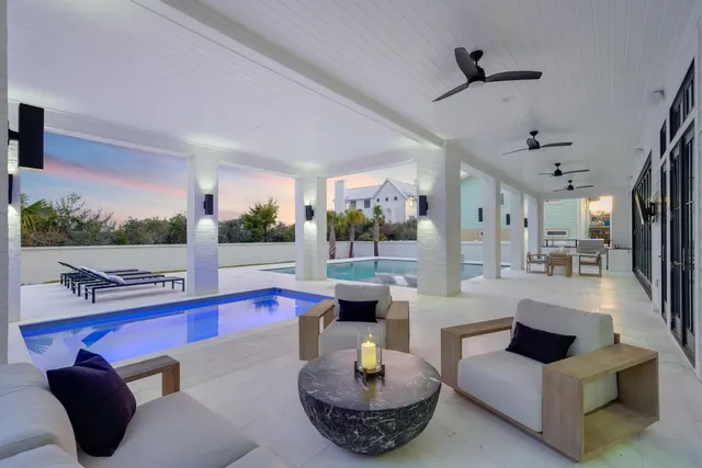 a large living room with a table chairs and flat screen tv