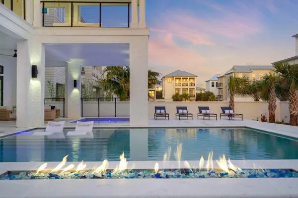 a living room with furniture a fireplace and a chandelier