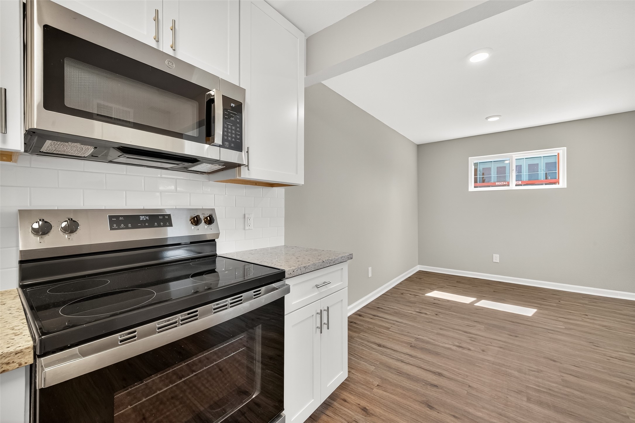 7047 Bissonnet Street, Unit 54 Houston, TX 77074 - Photo 18 of 30 a kitchen with a stove and a microwave