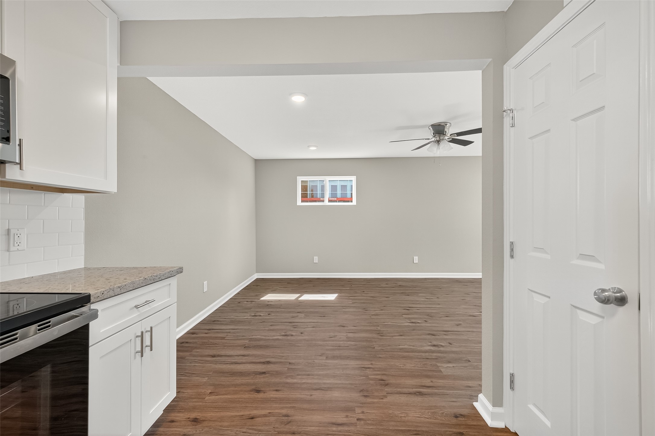 7047 Bissonnet Street, Unit 54 Houston, TX 77074 - Photo 19 of 30 a view of an empty room with wooden floor and cabinets