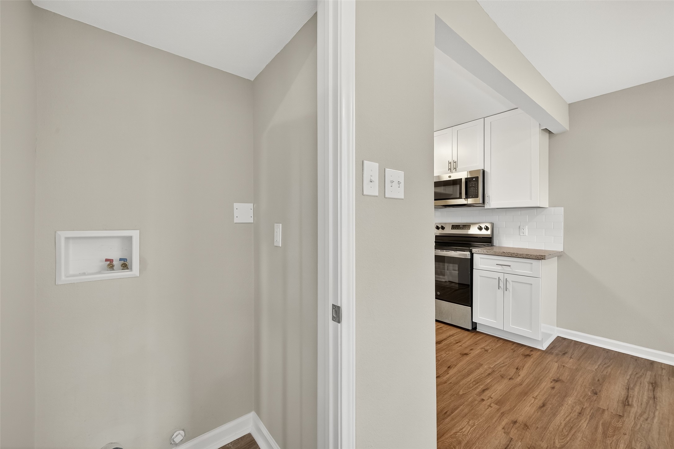 7047 Bissonnet Street, Unit 54 Houston, TX 77074 - Photo 21 of 30 a kitchen with white cabinets and appliances