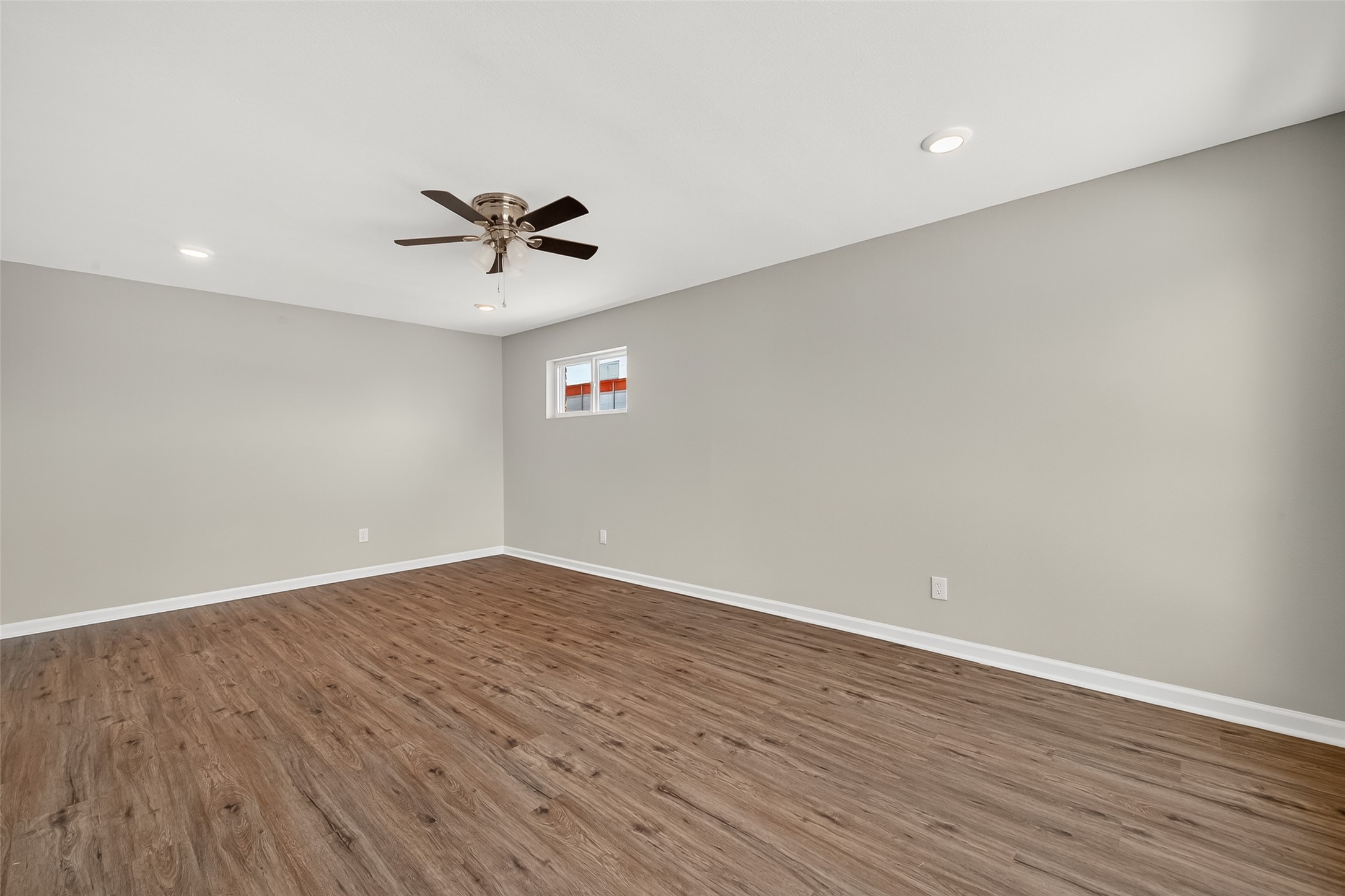 7047 Bissonnet Street, Unit 54 Houston, TX 77074 - Photo 24 of 30 a view of a room with wooden floor and a ceiling fan
