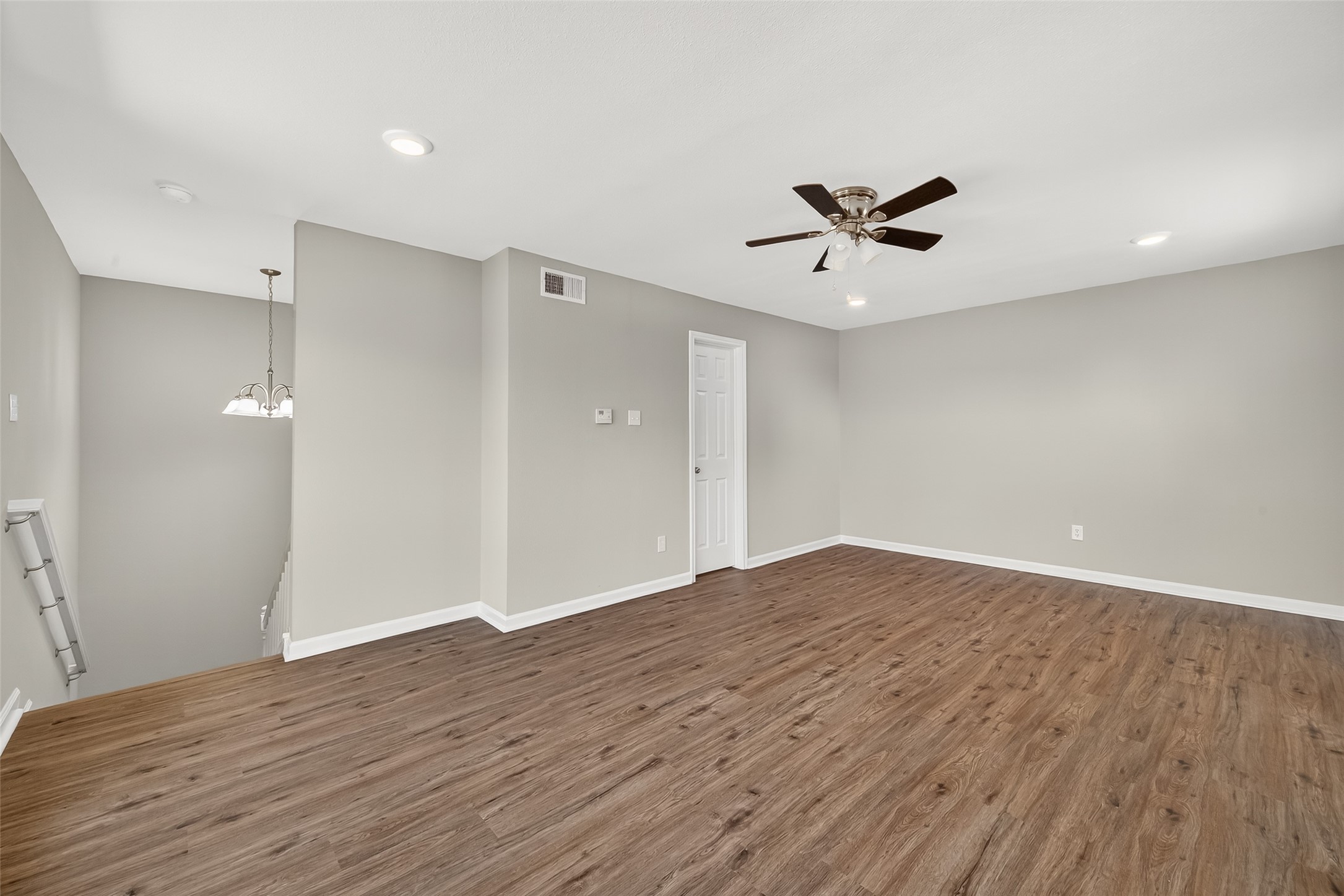 7047 Bissonnet Street, Unit 54 Houston, TX 77074 - Photo 25 of 30 an empty room with wooden floor and ceiling fan