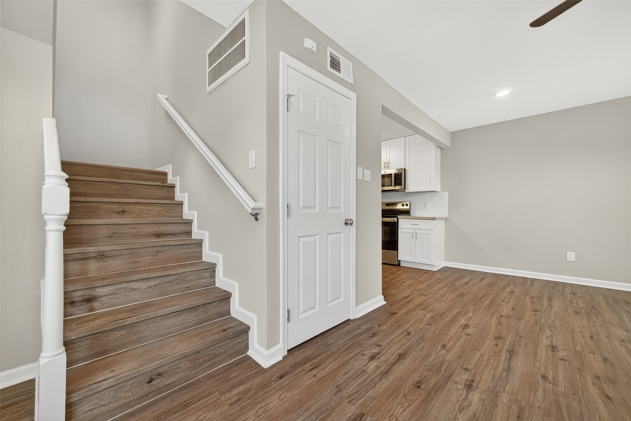 7047 Bissonnet Street, Unit 54 Houston, TX 77074 - Photo 9 of 30 a view of a hallway with wooden floors and staircase