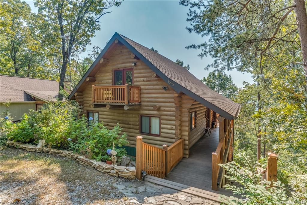 a view of a house with wooden fence