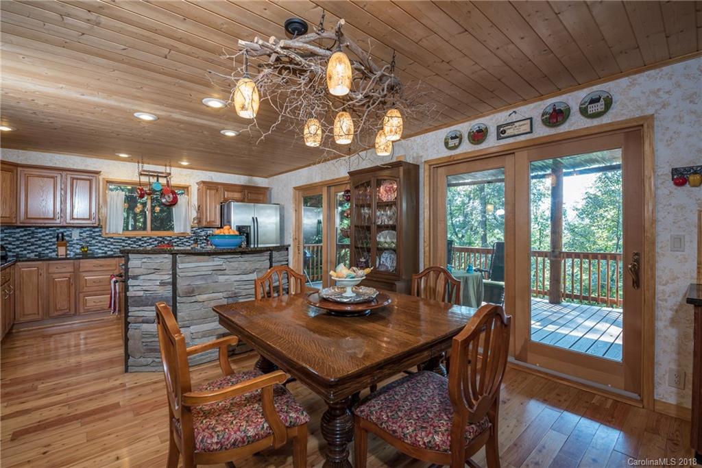 185 Caledonia Road Landrum, SC 29356 - Photo 13 of 30 a view of a dining room with furniture window and wooden floor