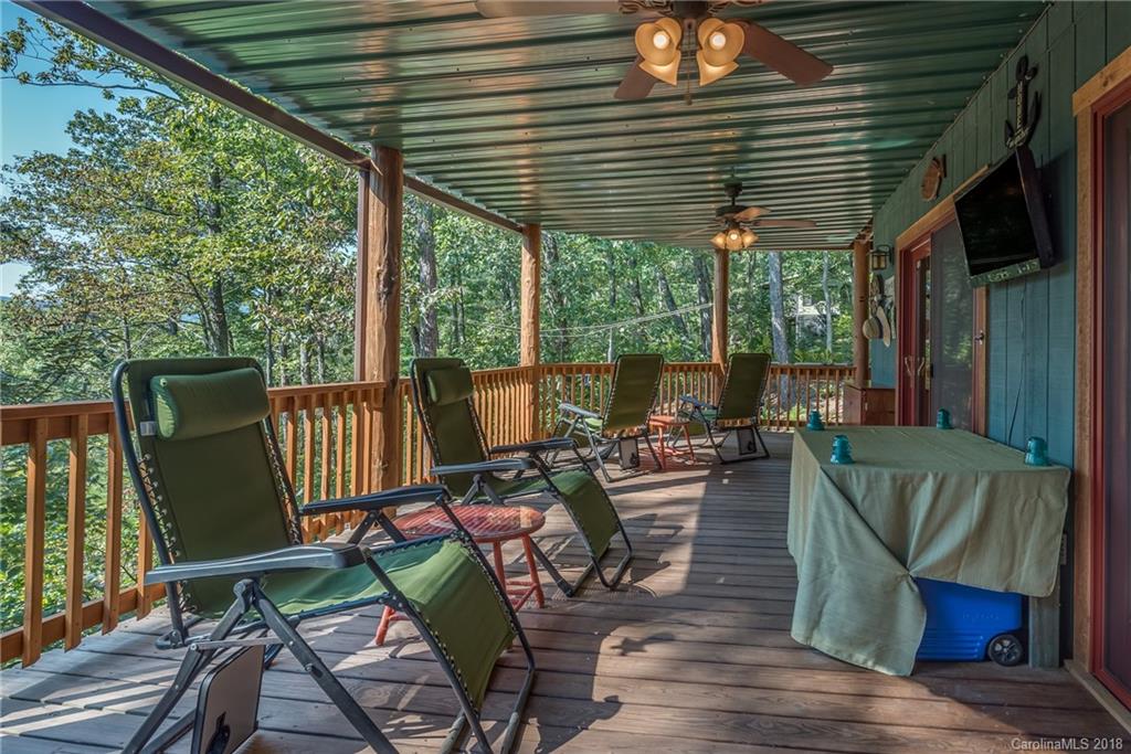 185 Caledonia Road Landrum, SC 29356 - Photo 18 of 30 a view of a patio with couches chairs potted plants and wooden floor