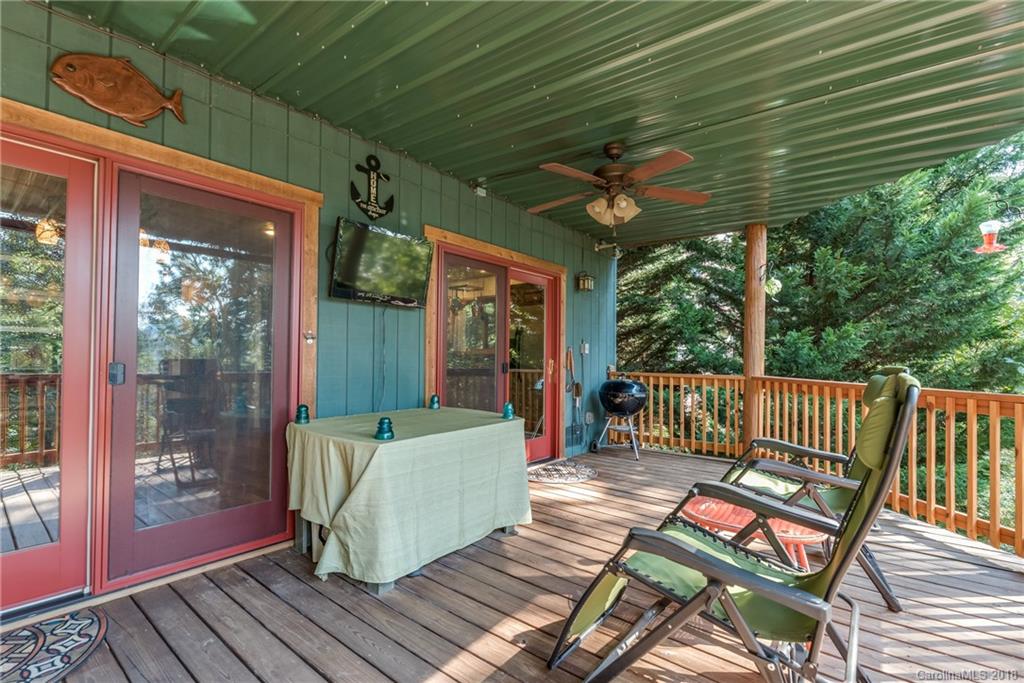 185 Caledonia Road Landrum, SC 29356 - Photo 19 of 30 a view of a chairs in wooden deck