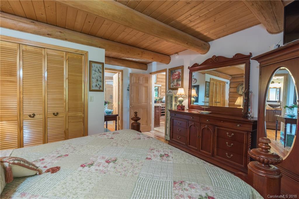 185 Caledonia Road Landrum, SC 29356 - Photo 22 of 30 a bedroom with a bed and wooden floor