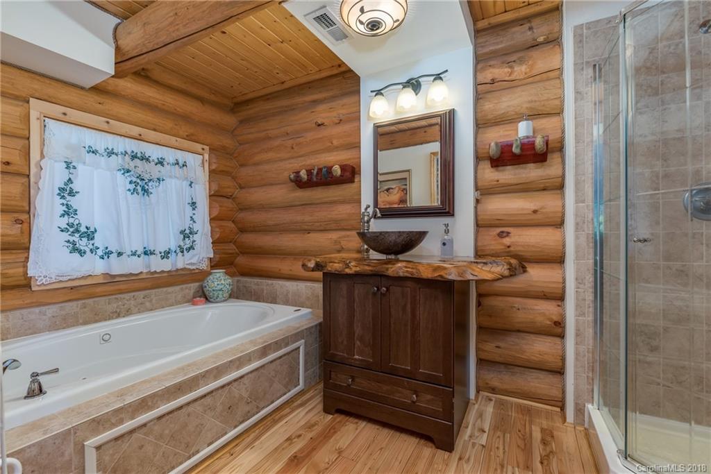 185 Caledonia Road Landrum, SC 29356 - Photo 23 of 30 a bathroom with a bathtub and shower
