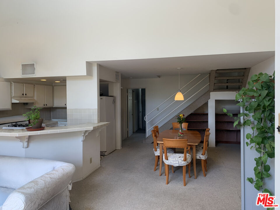11767 Iowa Avenue, Unit 10 Los Angeles, CA 90025 - Photo 3 of 8 a dining room with furniture and window