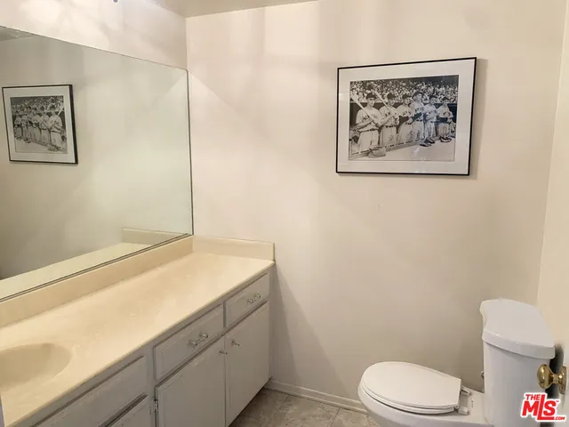 a bathroom with a toilet sink and vanity