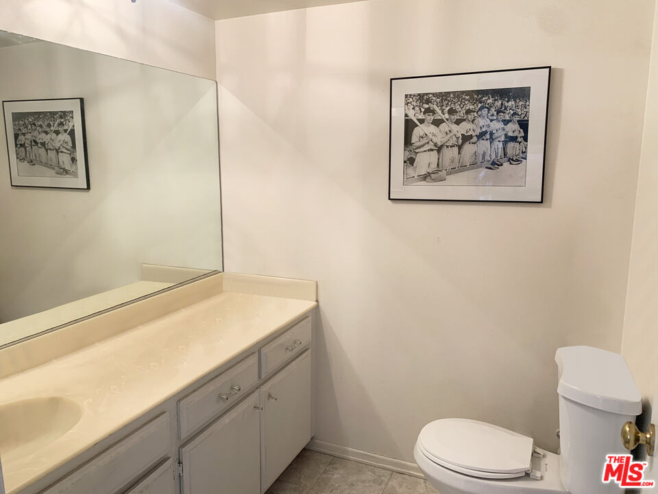 11767 Iowa Avenue, Unit 10 Los Angeles, CA 90025 - Photo 6 of 8 a bathroom with a toilet sink and vanity
