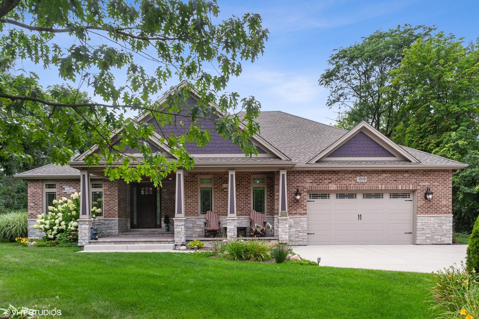 a front view of a house with a yard and porch