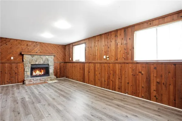 wooden floor in an empty room with a fireplace