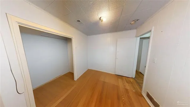 a view of a room with wooden floor