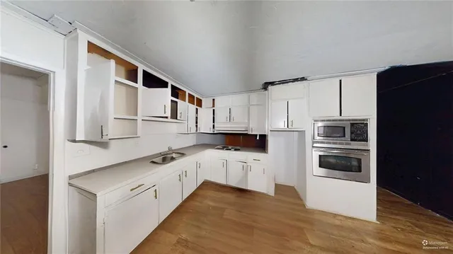 a kitchen with stainless steel appliances granite countertop a refrigerator and a stove top oven