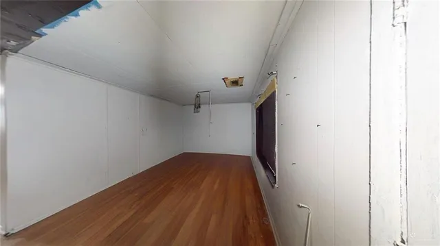 a view of a room with wooden floor