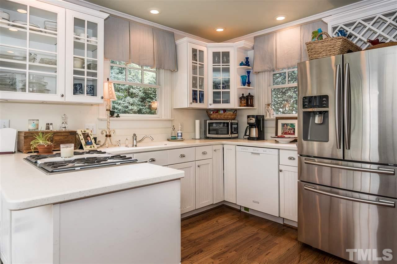 2320 Byrd Street Raleigh, NC 27608 - Photo 11 of 25 a kitchen with stainless steel appliances a refrigerator sink and cabinets