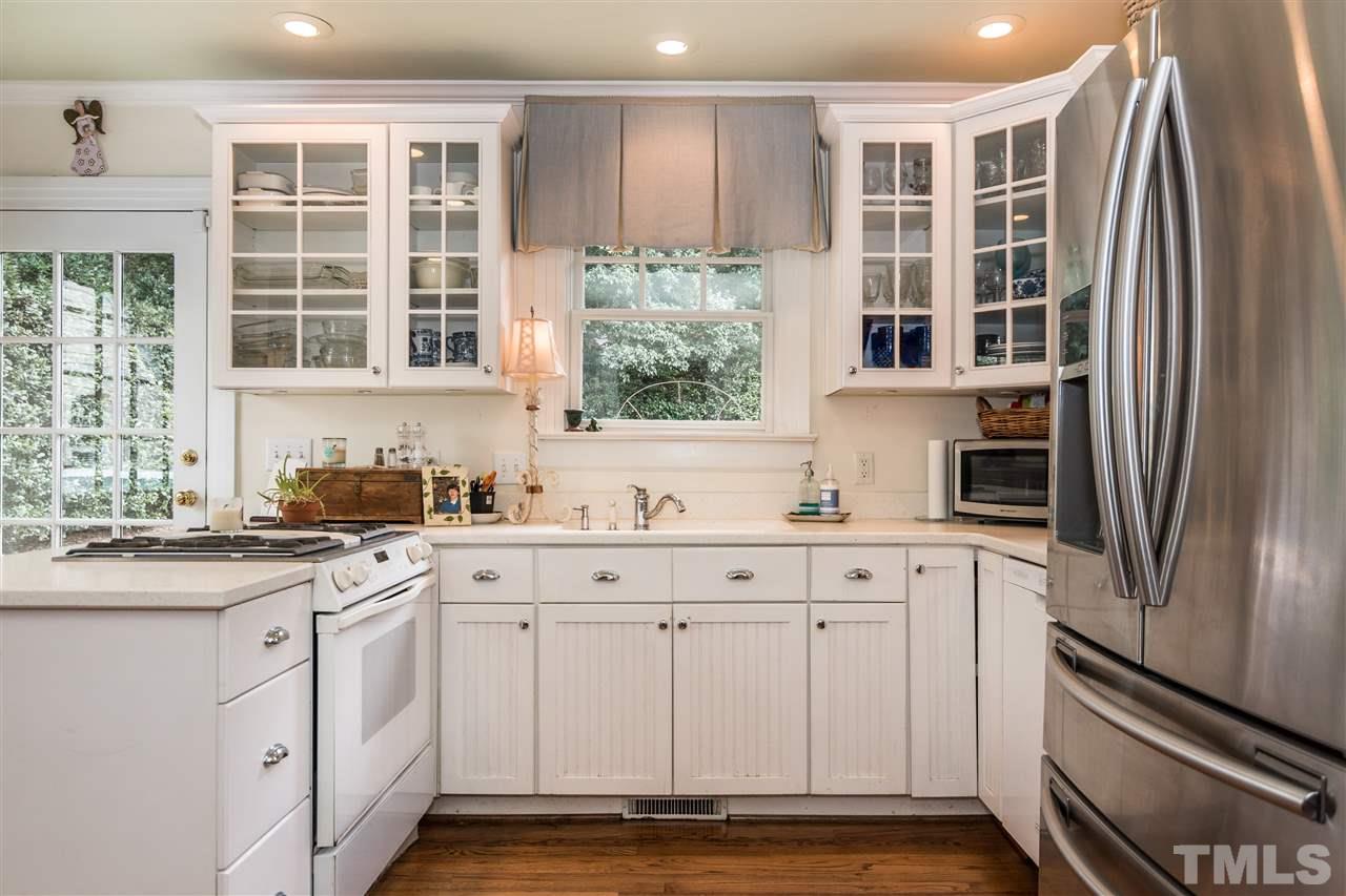 2320 Byrd Street Raleigh, NC 27608 - Photo 12 of 25 a kitchen with stainless steel appliances granite countertop a refrigerator and a sink