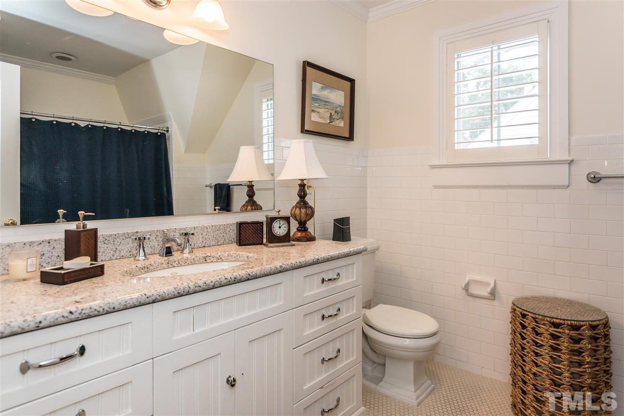 2320 Byrd Street Raleigh, NC 27608 - Photo 21 of 25 a bathroom with a granite countertop toilet a sink and a mirror