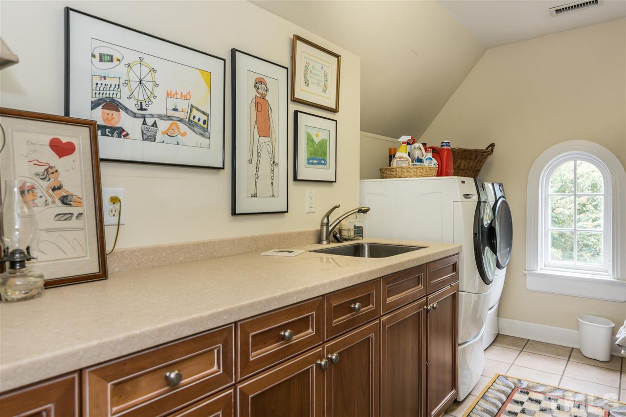 2320 Byrd Street Raleigh, NC 27608 - Photo 23 of 25 a utility room with a sink a washer and dryer