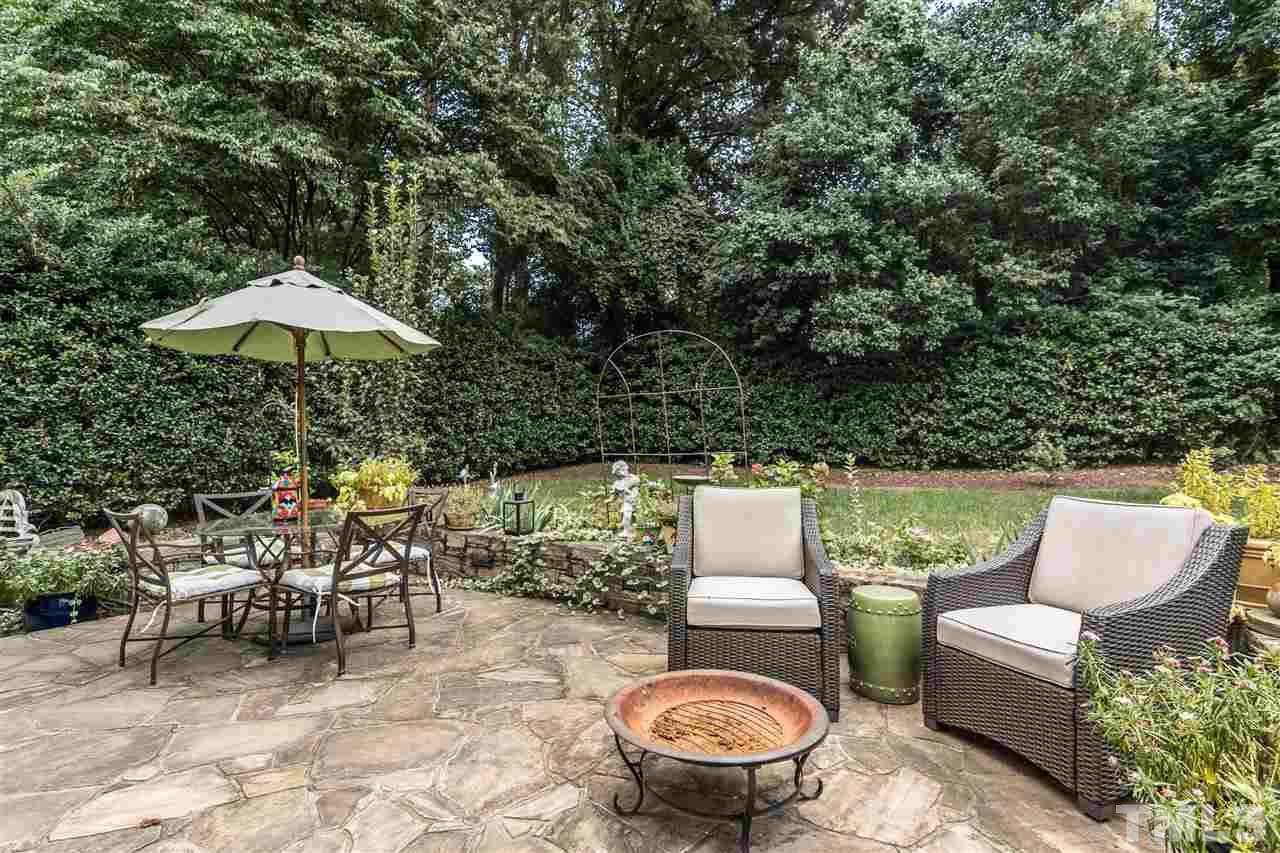 2320 Byrd Street Raleigh, NC 27608 - Photo 24 of 25 a view of a patio with couches table and chairs under an umbrella with a barbeque