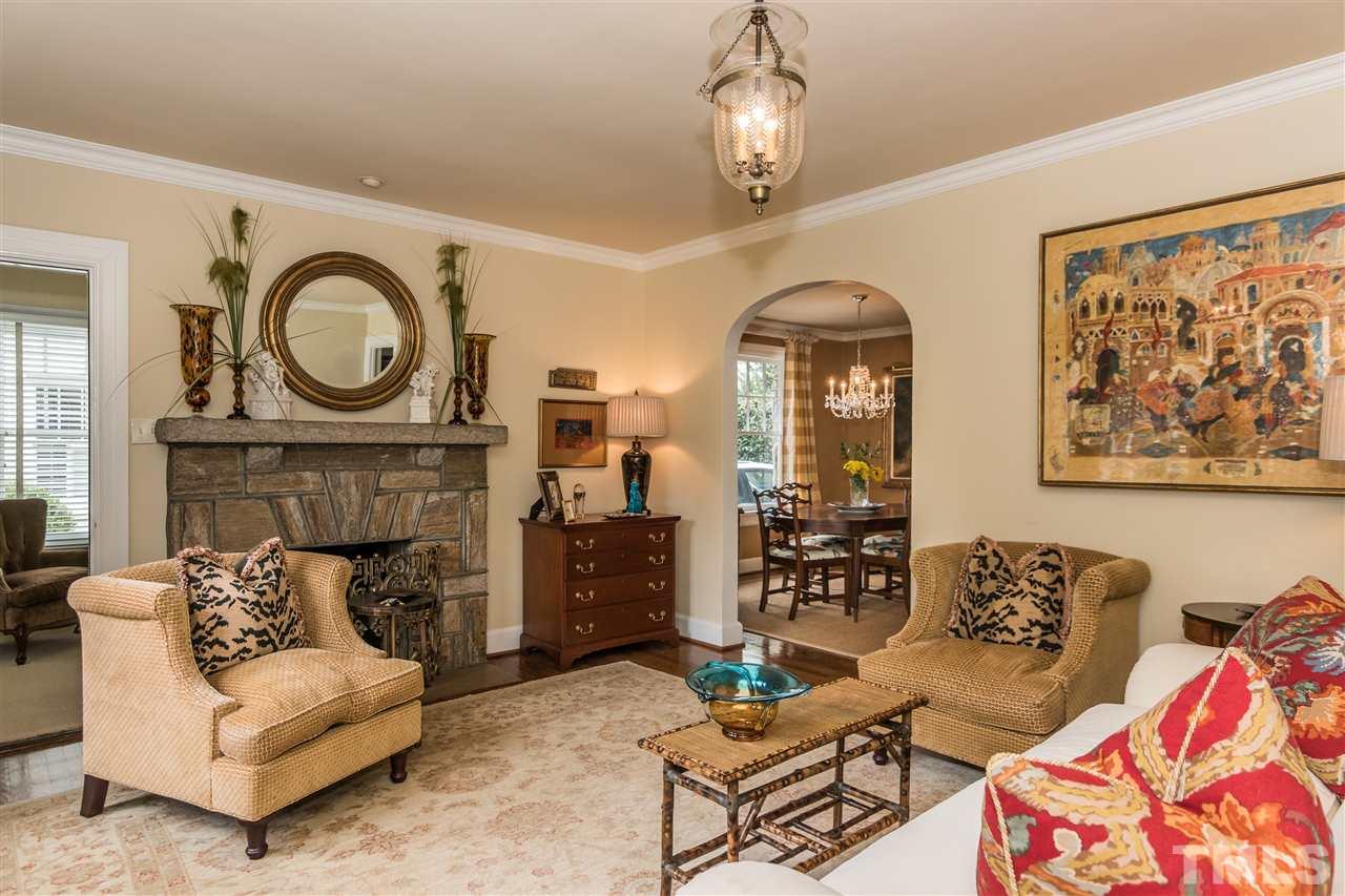 2320 Byrd Street Raleigh, NC 27608 - Photo 4 of 25 a living room with furniture a chandelier and a fireplace