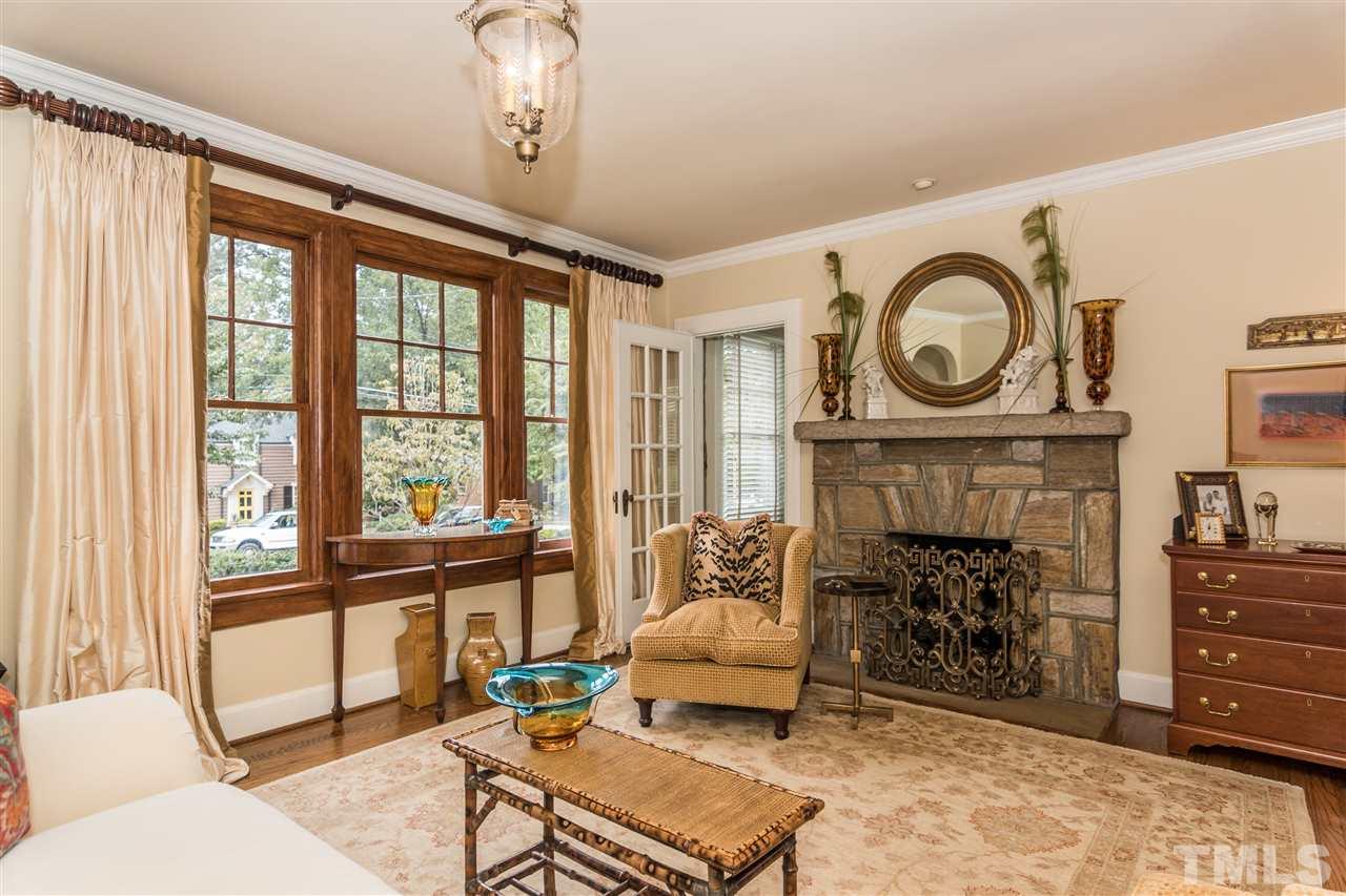 2320 Byrd Street Raleigh, NC 27608 - Photo 5 of 25 a living room with furniture a fireplace and a floor to ceiling window