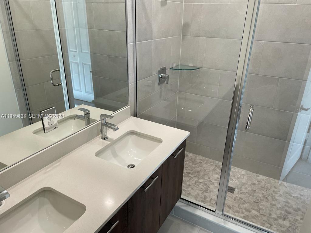 4657 Northwest 83rd Path Doral, FL 33166 - Photo 11 of 23 a bathroom with a sink and a mirror