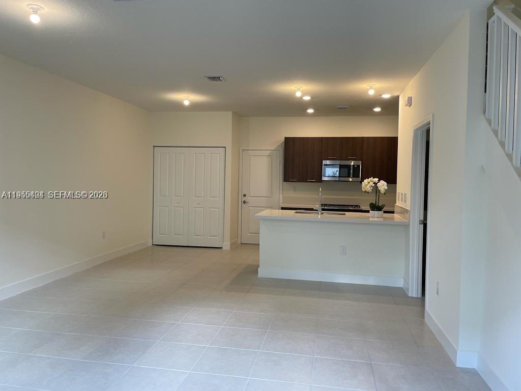 4657 Northwest 83rd Path Doral, FL 33166 - Photo 6 of 23 a view of kitchen with refrigerator sink and microwave