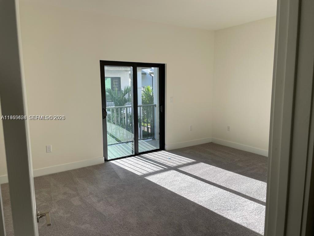 4657 Northwest 83rd Path Doral, FL 33166 - Photo 9 of 23 a view of an empty room with glass door