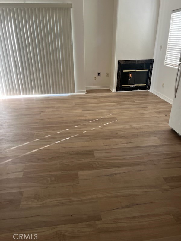 306 Lampman Way Placentia, CA 92870 - Photo 14 of 25 a view of an empty room with wooden floor and a fireplace