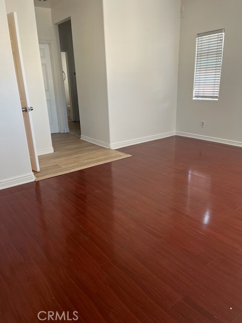 306 Lampman Way Placentia, CA 92870 - Photo 16 of 25 an empty room with wooden floor and windows