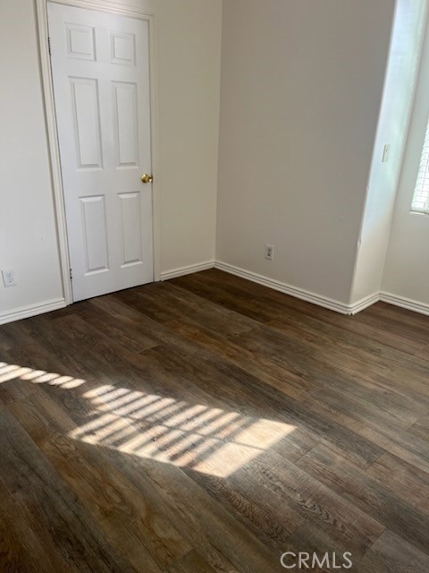 306 Lampman Way Placentia, CA 92870 - Photo 22 of 25 a view of an empty room with wooden floor and a window