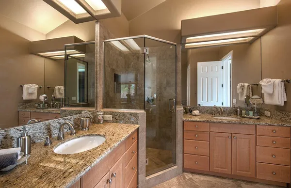 a bathroom with a granite countertop sink mirror and double