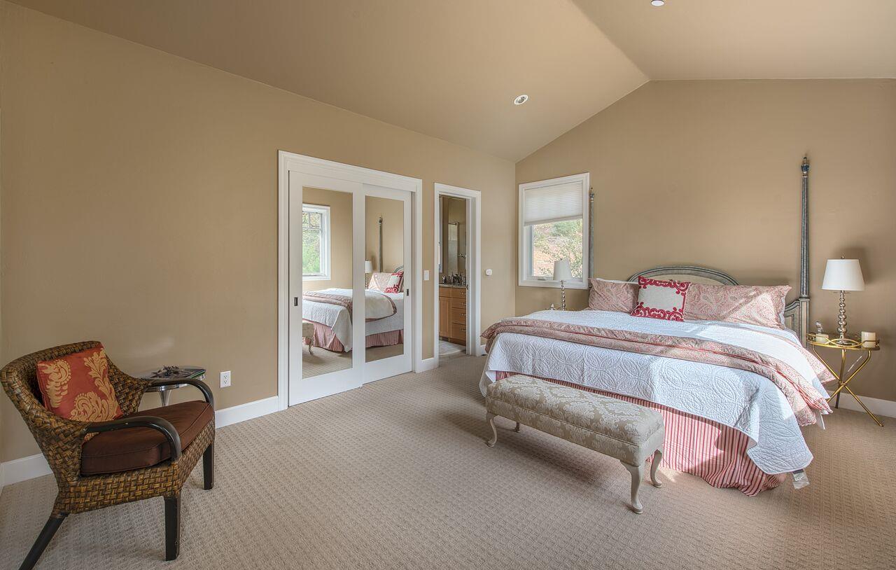 62 Corona Road Carmel, CA 93923 - Photo 23 of 28 a spacious bedroom with a bed and chair