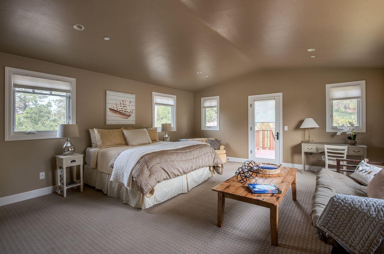 62 Corona Road Carmel, CA 93923 - Photo 25 of 28 a spacious bedroom with a bed and a couch