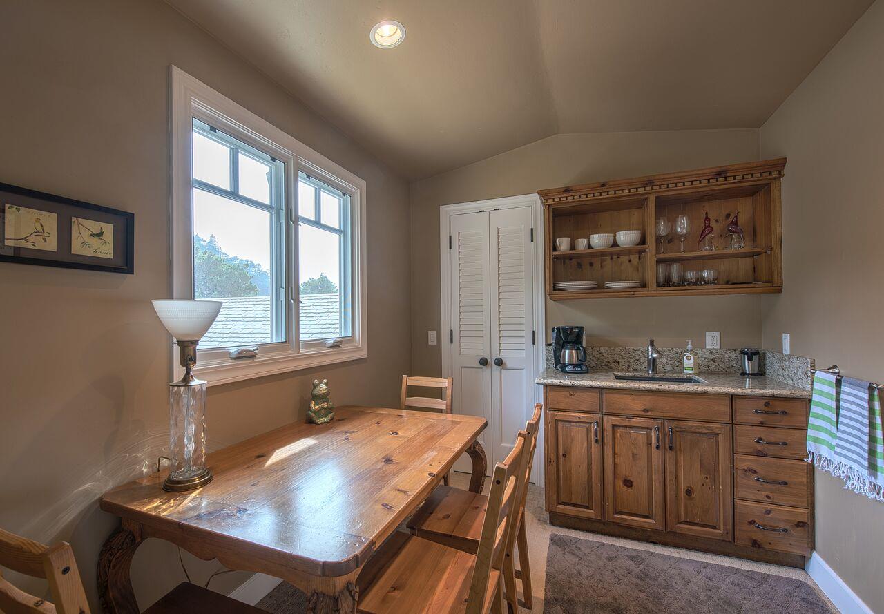 62 Corona Road Carmel, CA 93923 - Photo 26 of 28 a kitchen with a stove a sink a dining table and chairs