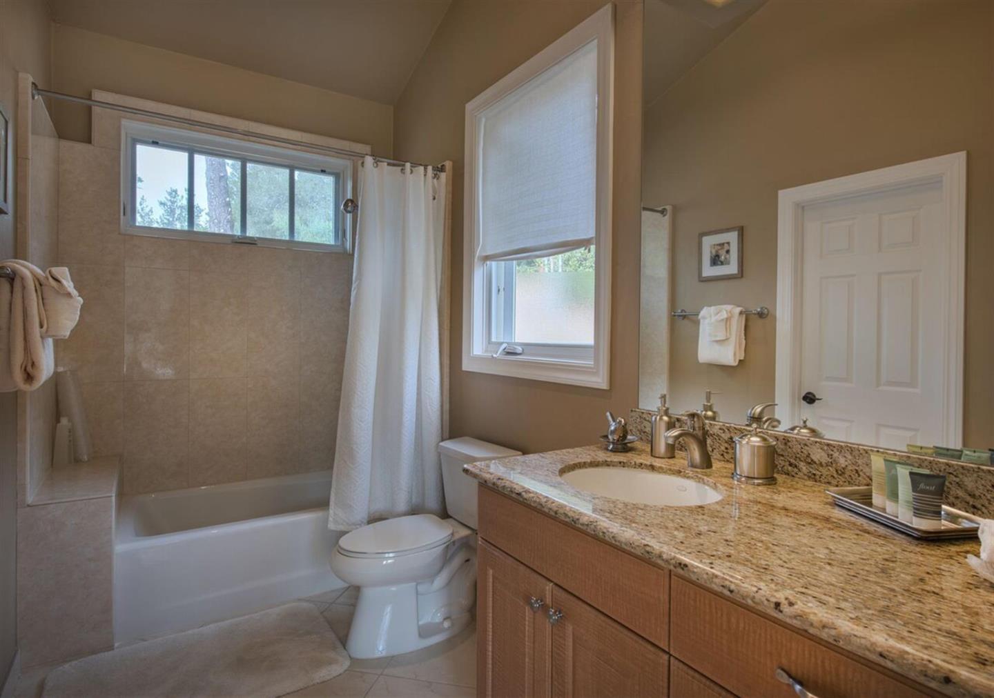 62 Corona Road Carmel, CA 93923 - Photo 27 of 28 a bathroom with a granite countertop sink a toilet and shower