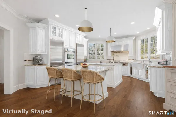 a large kitchen with a table and chairs