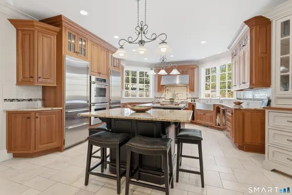 a kitchen with kitchen island granite countertop wooden cabinets and counter space