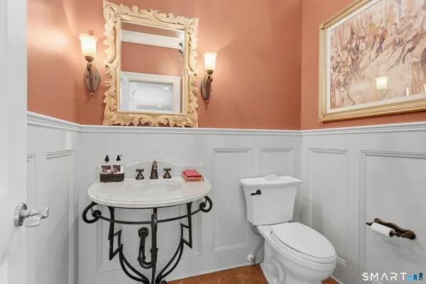 a bathroom with a sink mirror and toilet
