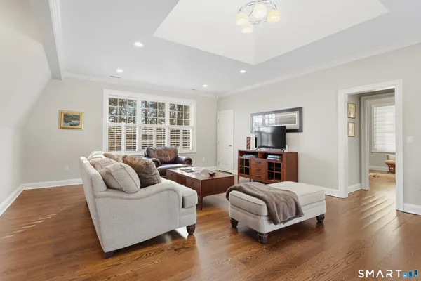a bedroom with furniture and a large window