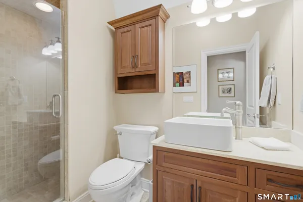 a white toilet sitting next to a bathroom sink