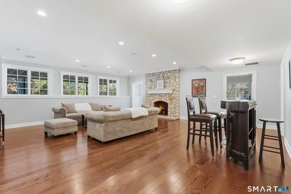 a living room with furniture wooden floor and a fireplace