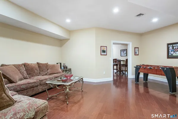 a living room with furniture and wooden floor